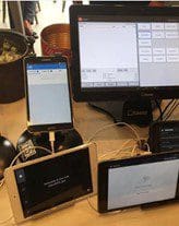 Multiple tablets and mobile devices plugged into a point of sale system.