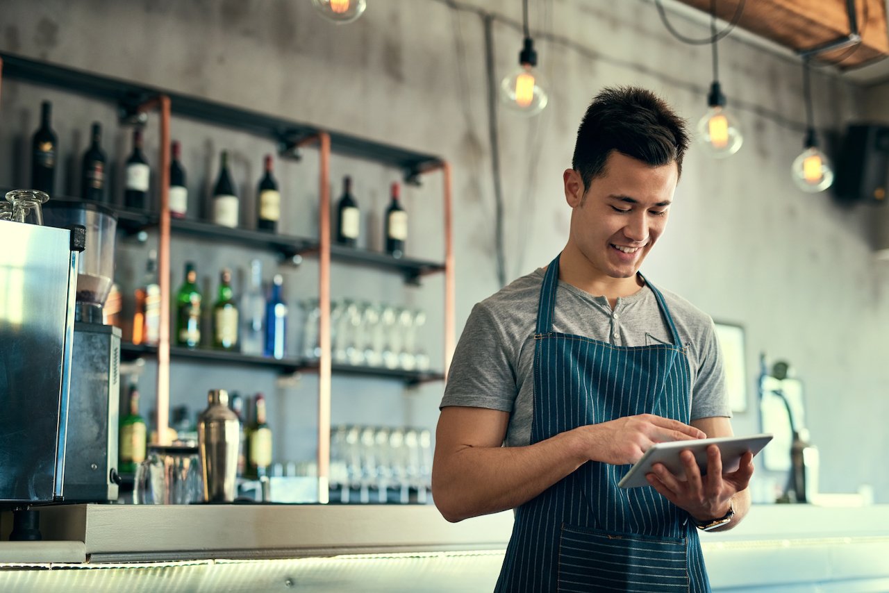 smiling-at-bar-with-ipad