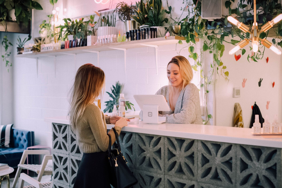 female customer purchasing at restaurant counter