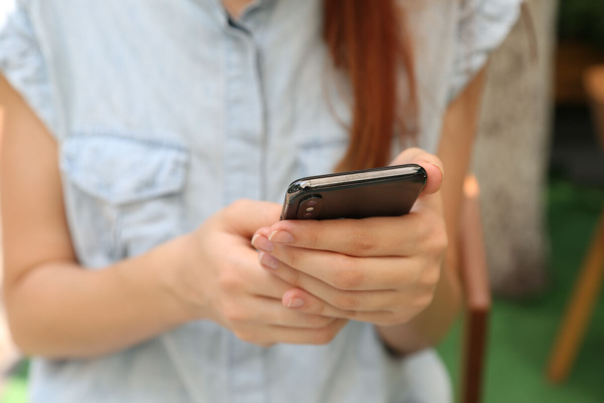 woman reading message on smartphone