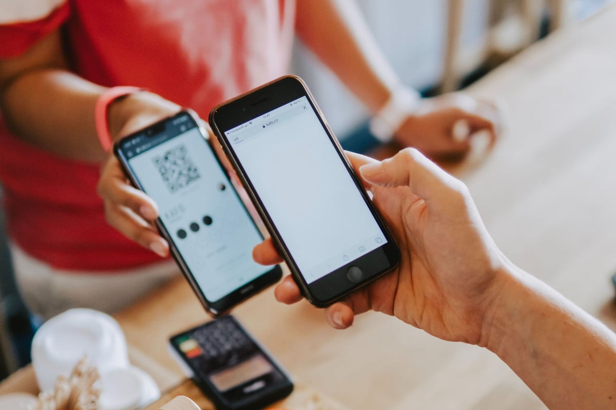 person scanning QR code at restaurant